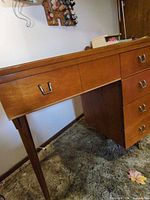 Front and side view of sewing cabinet showing drawers, legs and handles