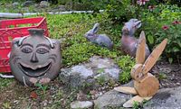 group shot of all four garden décor items placed outdoors