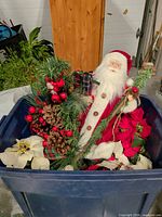 Overview of tote showing Santa figurine, greenery pick, poinsettias