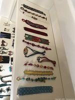 All 14 bracelets laid out to show variety of styles and sizes