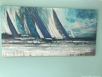 Front view of entire sailboats painting on wall