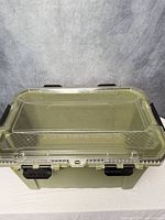 Top view showing olive green container and clear lid with black latches