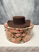 Hat positioned on floral hat box showing overall lot