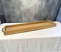 Top perspective of rectangular wooden tray showing full form and one wrought iron handle