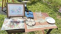 Overview of lot on outdoor table showing all items