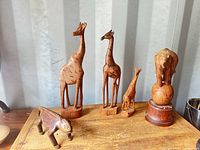 Group view of five wooden animal figures on table