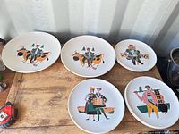Five plates front view showing folk art designs