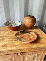 All three items on wooden surface, front view