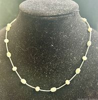 Necklace displayed on bust showing bead spacing