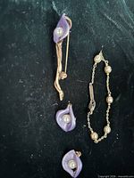 Earrings pair, brooch and bracelet grouped together