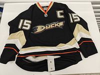 Full front view showing logo, number 15 sleeves, captain C patch