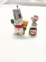 Snowman and teddy bear thimbles side by side
