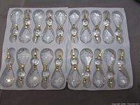 Two plastic trays holding 20 clear faceted chandelier drops