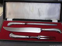 open case displaying knife, fork and steel