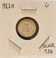 Coin in cardboard flip, reverse side visible with crown, wreath, date 1882, H mint mark