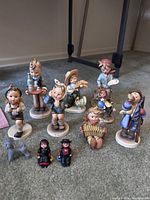 Group shot of all ten figurines on carpeted floor