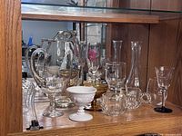 Cabinet shelf with assorted clear, amber and milk glassware pieces