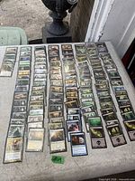 Wide view of entire spread of MTG cards laid out in rows on table