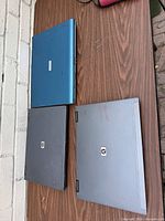 Top view of three closed laptops on table