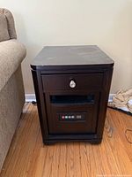 Front angled view showing overall table, drawer, heater vent, control panel