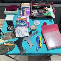 Top view showing majority of items: books, desk organizer, stone pieces, pencils, stands