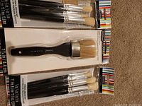 Front view of three sealed ArtMinds brush packs
