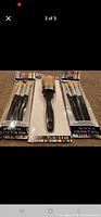 Three sealed ArtMinds brush packs laid out side by side