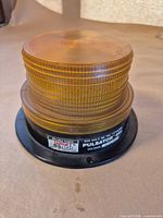 Side view of amber beacon showing label and base