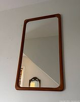 Full view of teak wall mirror on wall