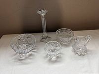 Group shot of all five cut glass pieces: candlestick, three bowls, creamer