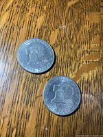Both coins reverse side on wood surface