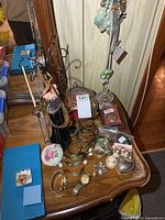 Overview of lot on dresser showing jewelry stand, watches, necklaces, bangles and trinket boxes