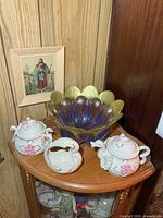 Entire lot on corner cabinet showing fruit bowl, porcelain cream and sugar pieces