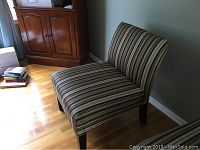 Front-right angled view of slipper chair with multicolored striped upholstery showing condition and style