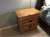 Nightstand showing top surface and two drawers with black metal hardware