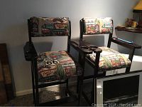 Two pool table stools side by side, showing the overall design, upholstery and carved cup holder arms.