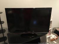 Front view of the 37 inch flat panel TV showing screen and stand.