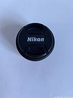 Front view showing Nikon-branded snap-on cap