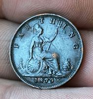 Reverse showing Britannia, legend FARTHING and date 1879 with wear and corrosion