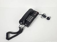 Full view of phone with handset on cradle and cords visible