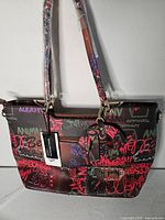 front view handbag with tag and graffiti print