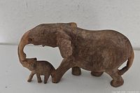Left side view of carved wood elephant with calf