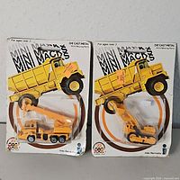 both Mini Macks vehicles in packaging