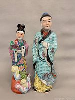Full view of both porcelain figurines standing side by side