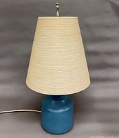 Full view of lamp with shade and finial