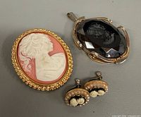 Brooch, pendant and earrings group shot