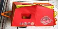 Closed camper showing red side panel with Barbie logo and litterbug sticker