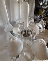 Full view of chandelier showing glass shades, arms and central column