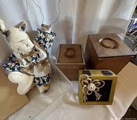 Stuffed cow, two wooden canisters, yellow planter box, part of clear tray