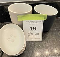 Two tumblers and stacked soap dishes showing colors and interiors